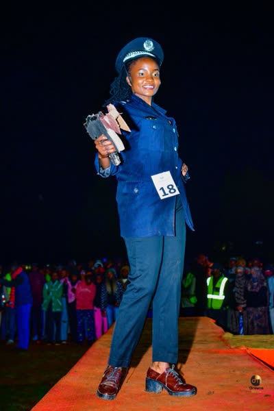 Runway walk in a uniform-styled outfit with contestant number 18, in front of the audience at Miss The Eldoret National Polytechnic 2025/26.